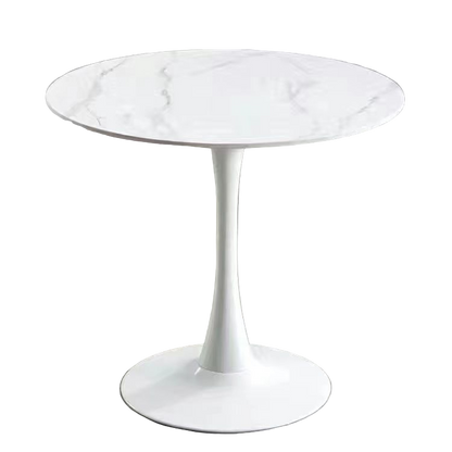 White round table with marble-like top on a gray floor.